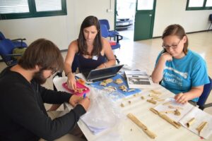 Katie and her colleagues examine bones from their study site, which is a mass grave of individuals dating back to the Sicilian Wars.